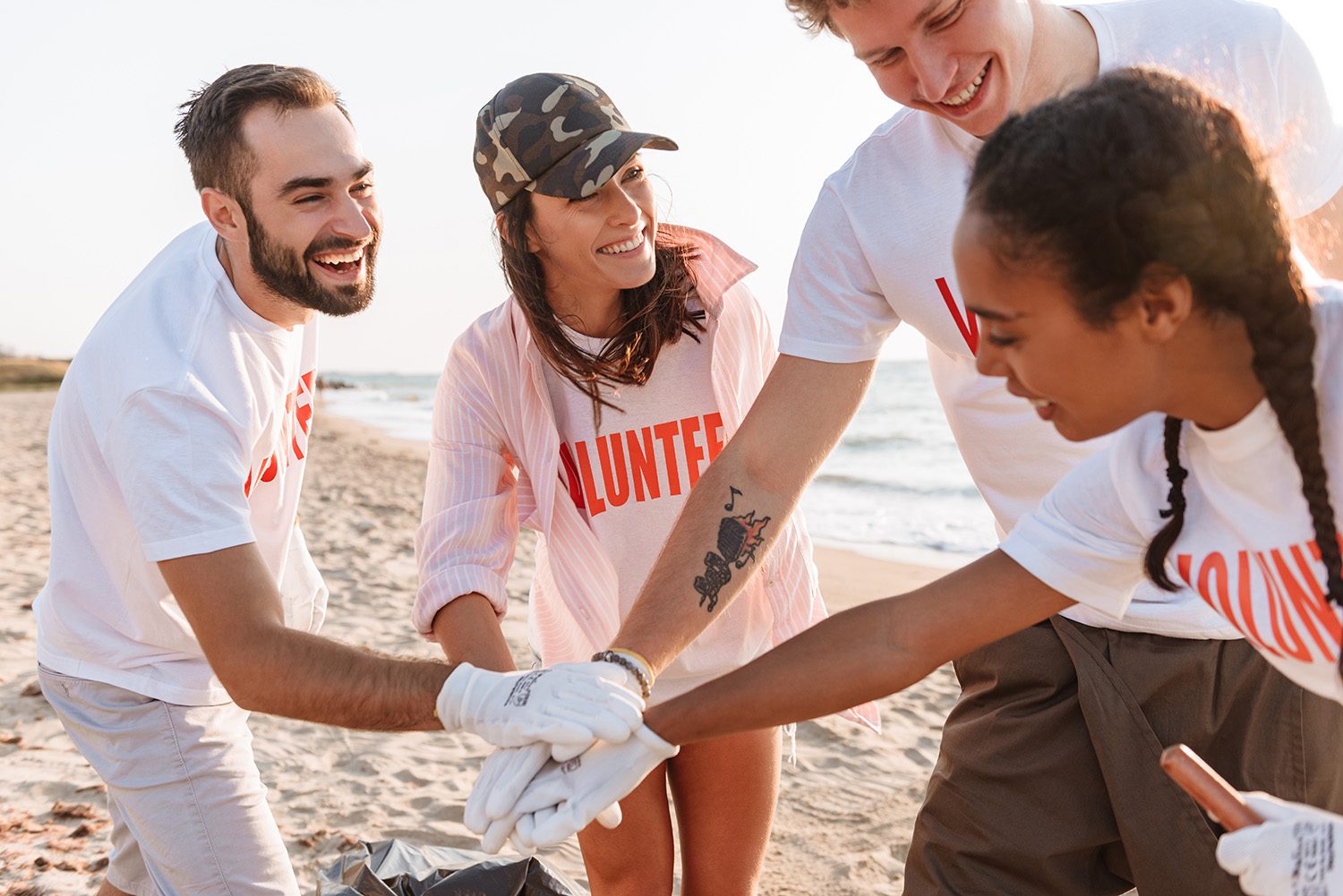 A group of volunteers working together on a beach cleanup.