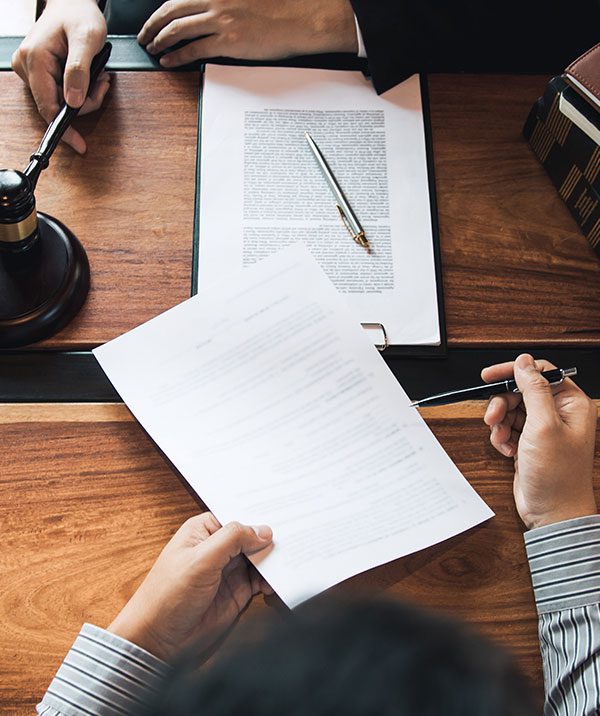 A lawyer reviewing documents with a client.