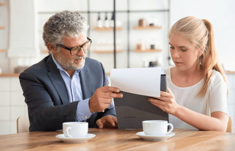 A man and woman reviewing paperwork.
