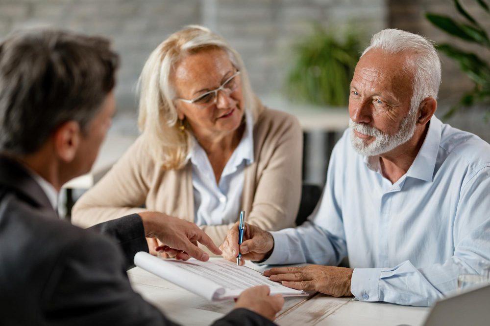 A couple speaking with a lawyer.